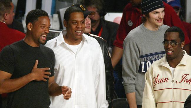 L-R: Will Smith, Jay Z, Ashton Kutcher, and Diddy at a 2004 basketball game. Picture: Vince Bucci/Gett