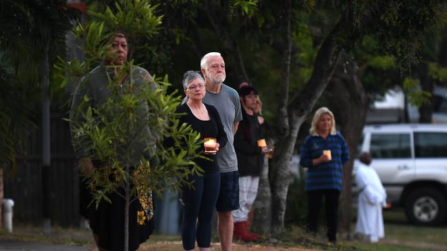 People stand outside their homes at dawn to commemorate Anzac Day in Brisbane, Saturday, April 25, 2019. Anzac Day is a national day of remembrance to commemorate the service and sacrifice of Australian and New Zealand service men and women. Due to COVID-19 restrictions marches and commemorative services have been banned for the first time in more than a century. (AAP Image/Dan Peled) NO ARCHIVING
