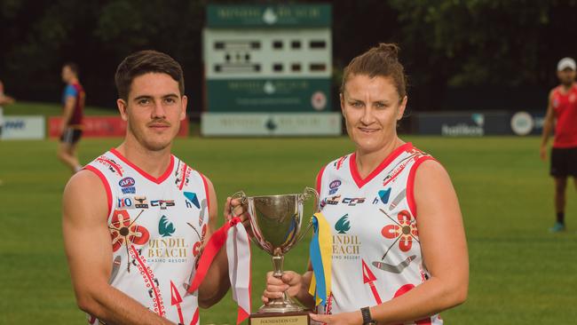 Waratah FC players Brodie Carroll and Lauren O’Shea with the Foundation Cup in jumpers designed by Sharona Bishop. Picture: Glenn Campbell.