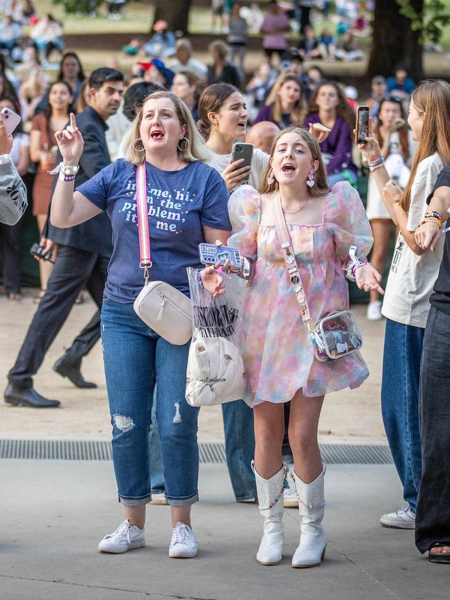 Fans enjoy the concert from outside the MCG. Picture: Jake Nowakowski