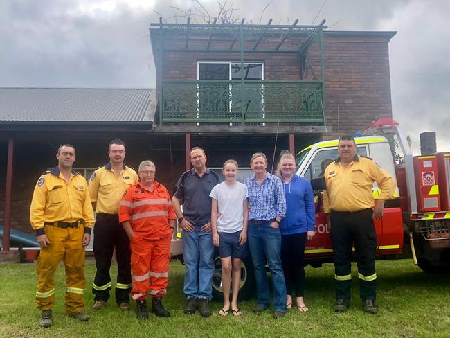 The De Friskbrom family (middle) with some of the people who saved their home. From left: Mark Ayliffe (RFS), Max Neimeyer (RFS), Chris Pittolo (SES) and Simon Bateman.