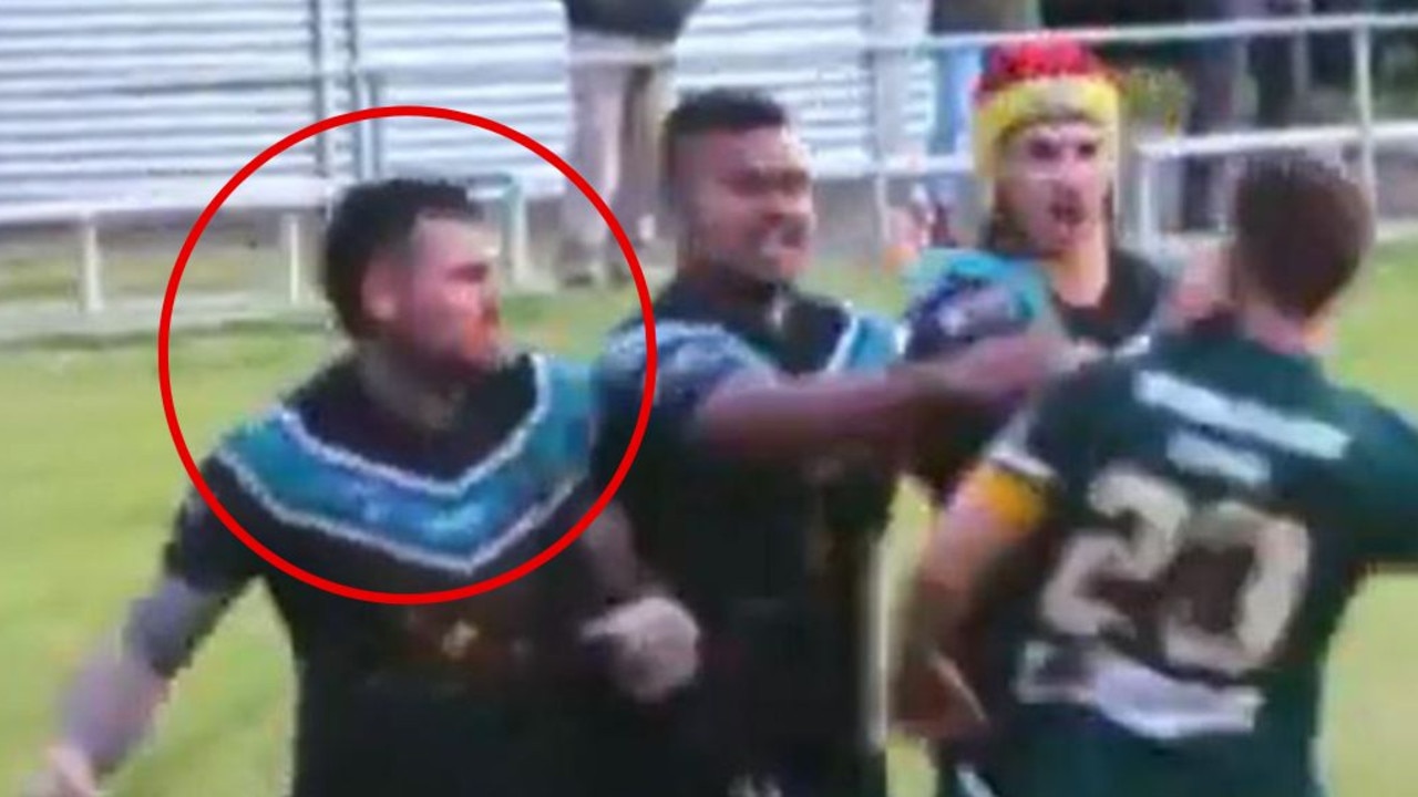 Josh Dugan throws punch in a country footy game.