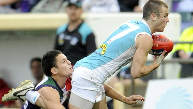 Fremantle’s Greg Broughton attempts to wrap up Port’s Robbie Gray. Picture: Jackson Flindell.