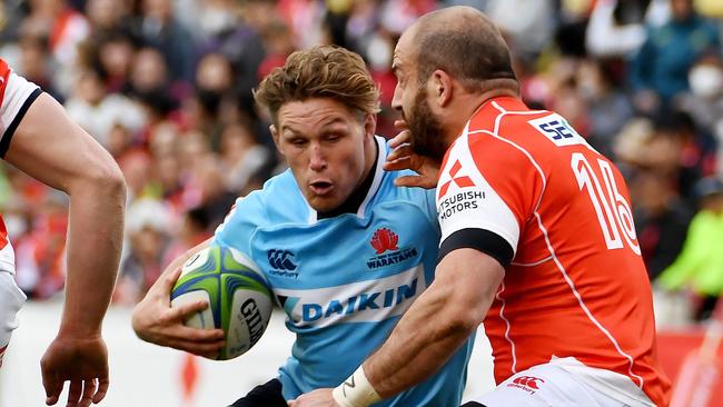 Michael Hooper of the Waratahs (L) hands off Jaba Bregvadze of the Sunwolves.