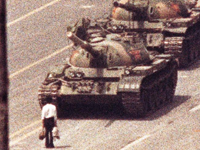 TAUS 60th Anniversary. A man stands in front of a convoy of tanks in the Avenue of Eternal Peace in Beijing, June 5, 1989. REUTERS/Arthur Tsang