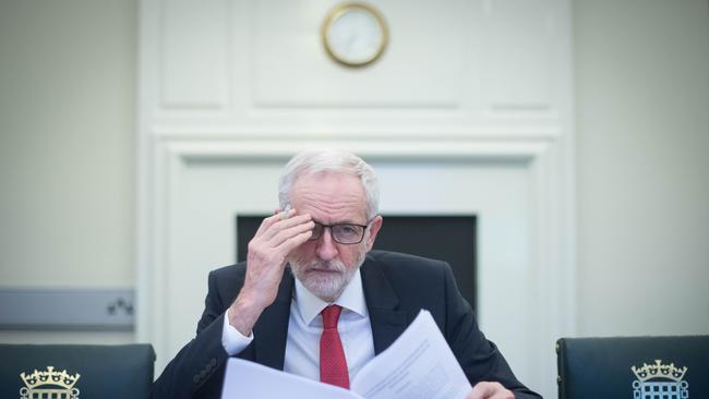 Britain's main opposition Labour Party leader Jeremy Corbyn poses with a copy of the Political Declaration setting out the framework for the future UK-EU relationship, in his office in the Houses of Parliament in London on April 2, 2019. - Prime Minister Theresa May said Tuesday she would ask the EU to delay Brexit again to avoid Britain crashing out of the bloc next week, signalling she could accept a closer relationship with Europe to break months of political deadlock. In a move which enraged the Brexit-supporting wing of her Conservative Party, she also offered to work with Labour main opposition leader Jeremy Corbyn, who favours closer ties with the European Union. Corbyn responded saying he was "very happy" to meet. (Photo by Stefan Rousseau / POOL / AFP)