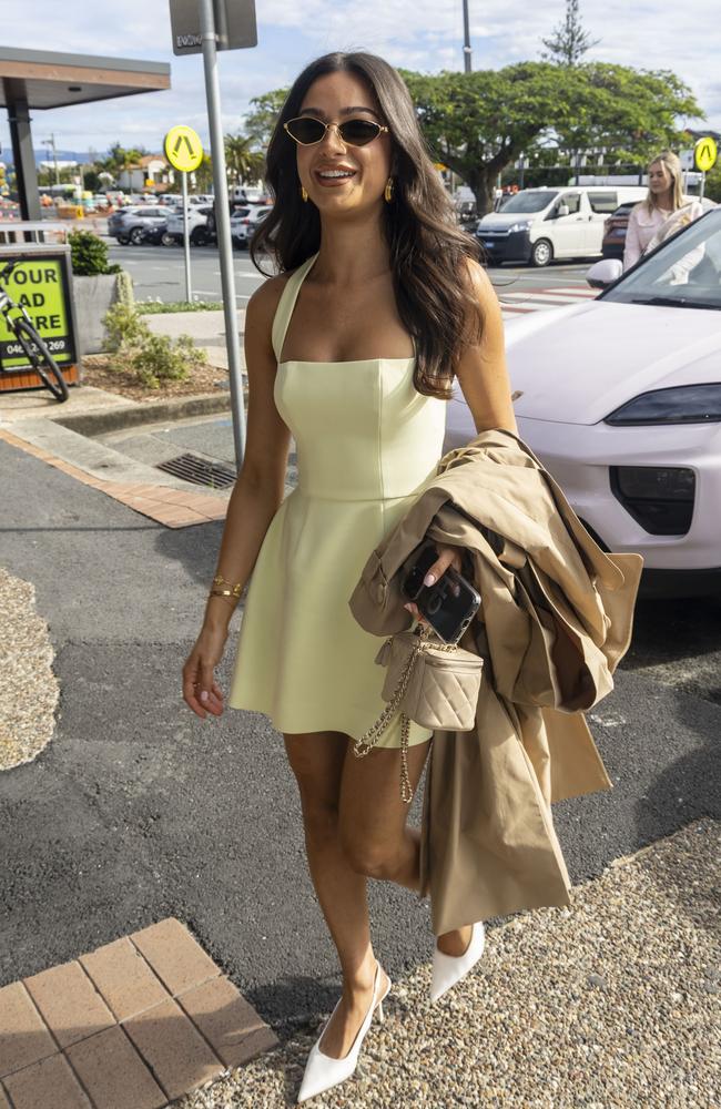 Hatzi accessorised in nude hues, including a cream bag and trench coat with white pointed heels. Picture: Media Mode