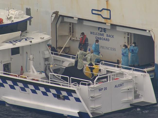 A police boat prepares to take an unwell crew member from the Ruby Princess yesterday. Picture: 7 News