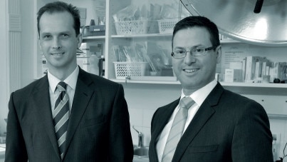 Markus Nikitins, left, is suing Dr Lang’s estate for $700,000. They are pictured in a 2017 Dextra Surgical practice newsletter published online.