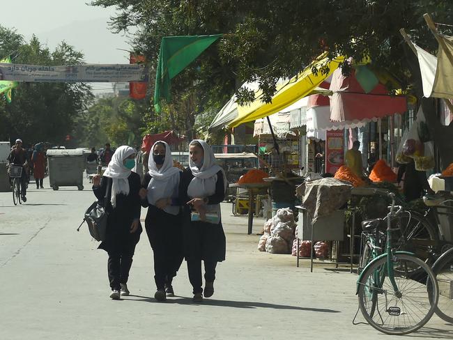 Afghan school girls walk through in a street in Kabul yesterday. Picture: AFP