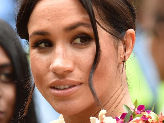 Britain's Meghan, the Duchess of Sussex (C) meets people at the University of the South Pacific in Suva on October 24, 2018. - British royal Meghan Markle passionately promoted female education in her first speech of the Oceania royal tour on October 24, telling students in Fiji of her own struggles to afford higher education. (Photo by PETER PARKS / AFP)