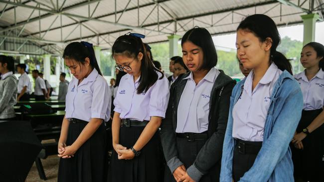 Classmates of the Wild Boars soccer team pray at the Maisai Prasitsart school before classes the morning as the third rescue mission to free the last four boys and their coach.