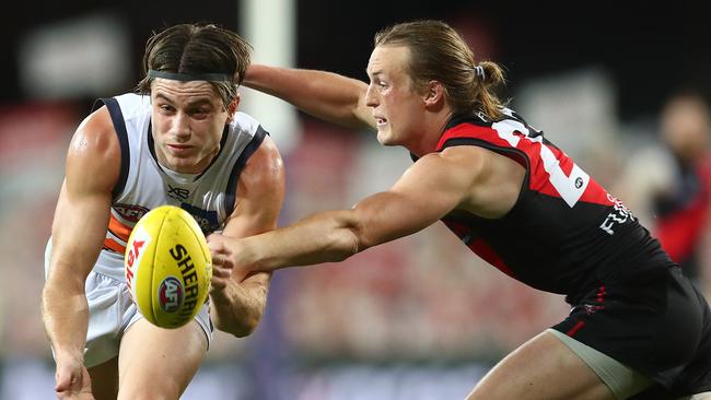 Giant Xavier O'Halloran does his best to evade Bomber Mason Redman on Friday night. Picture: Chris Hyde/Getty Images