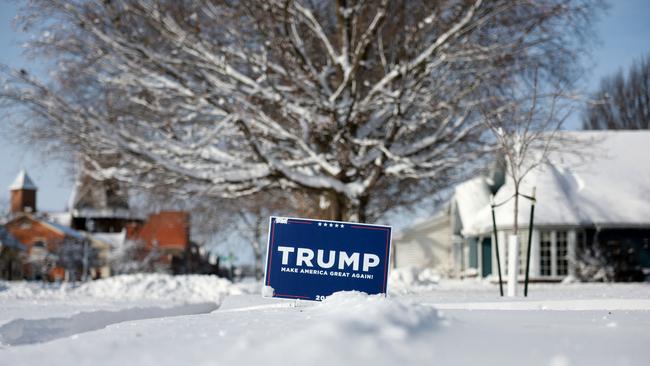 A campaign sign supporting Republican presidential candidate former President Donald Trump is stuck in the snow in Pella, Iowa. Picture: Joe Raedle/Getty Images/AFP