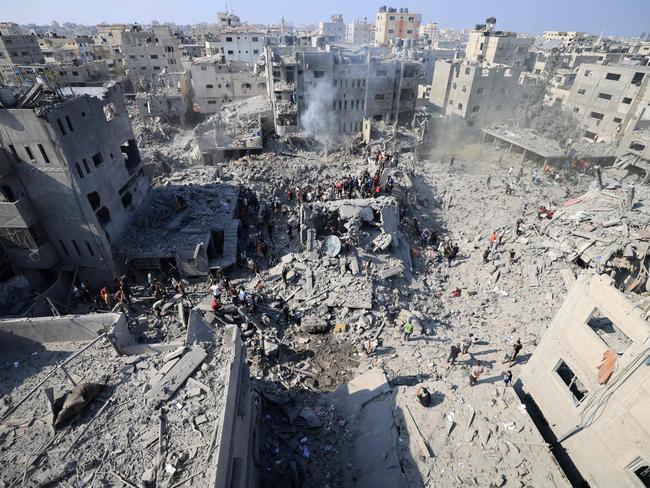 People check the rubble of buildings destroyed in an Israeli strike on the Bureij refugee camp in the central Gaza Strip. Picture: AFP