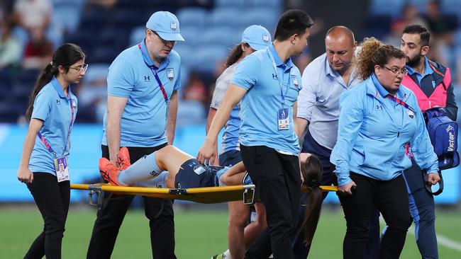 Sydney FC head coach Ante Juric consoles Natalie Tobin as she is stretchered from the field. (Photo by Mark Metcalfe/Getty Images)