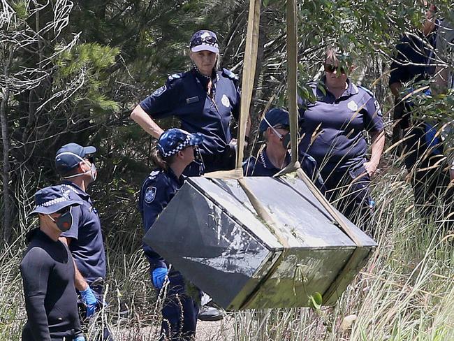 Toolbox murder -  Police retrieve a metal box from a dam near Srubby Creek in Kingston, double murder Logan. Pic Jono Searle.