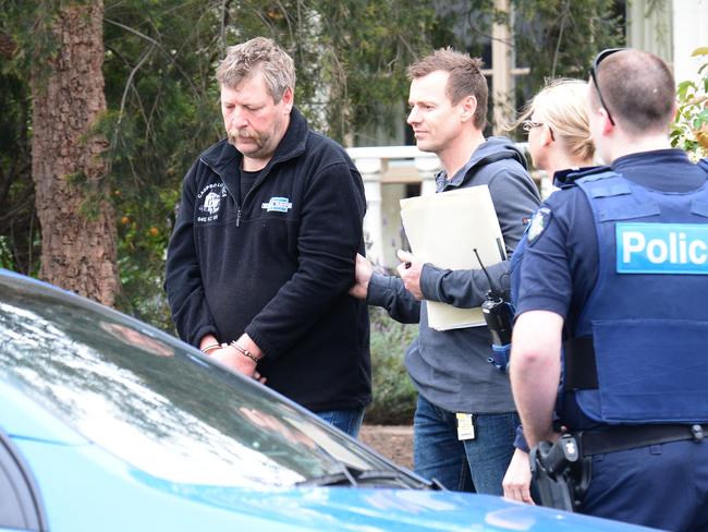 Police with Stephen “Stiffy” Rogers outside his Melbourne home.