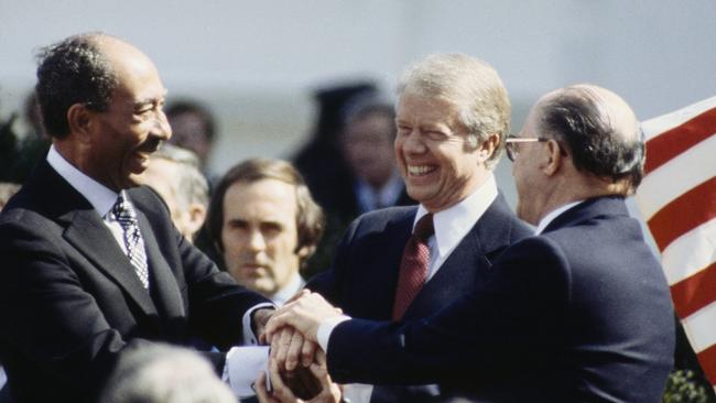 Egyptian president Anwar Sadat (left), Jimmy Carter and Israeli prime minister Menachem Begin after signing the Camp David Accords. Picture: UPI/Bettmann Archive/Getty Images