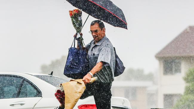 A man struggles to avoid a soaking on the Gold Coast. Picture: Nigel Hallett