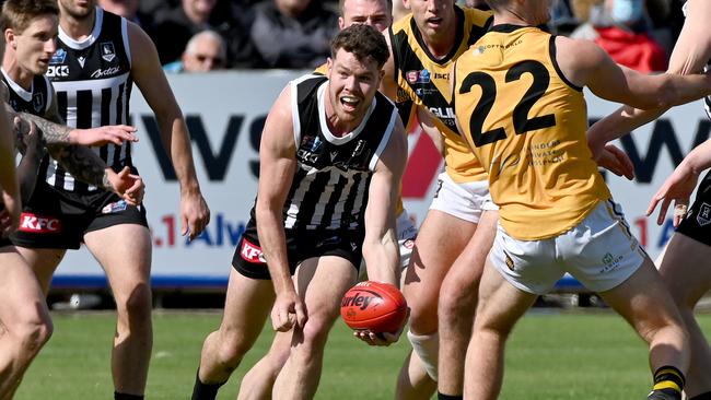 Tom Corcoran gets a handball away for Port Adelaide. Picture: Naomi Jellicoe