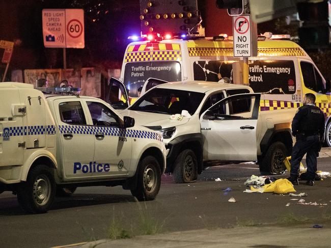 The white Toyota HiLux riddled with bullet holes is looked over by police. Picture: Liam Mendes