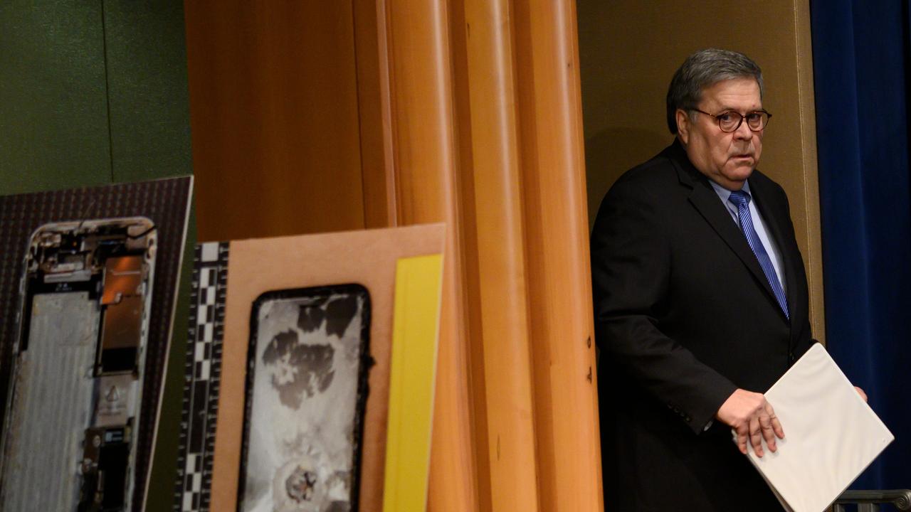 US Attorney-General, William Barr walks past pictures of the shooter's cellphone as he arrives at a press conference. Picture: ANDREW CABALLERO-REYNOLDS / AFP)