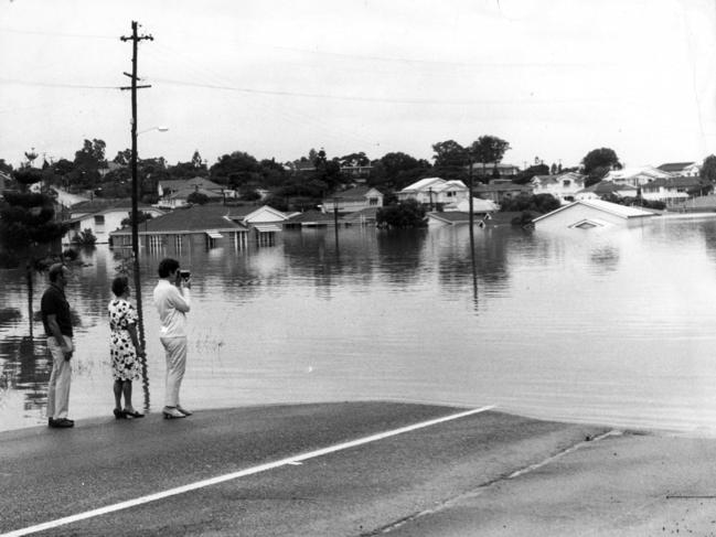 Residents taking photos of floodwaters at Fairfield Road .