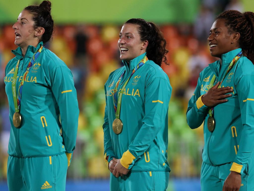 Alicia Quirk, Emilee Cherry, and Ellia Green celebrate winning the 2016 Rio Olympic Women's Rugby Sevens gold medal game over New Zealand. Picture: Adam Head