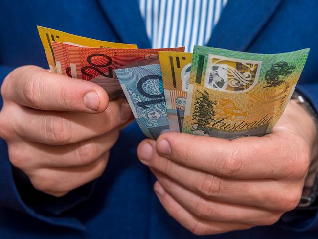 Male hands holding australias dollar banknotes closeup