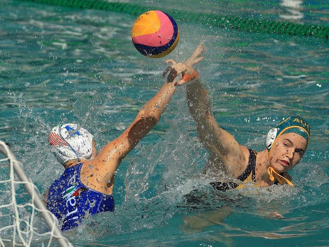 Ash Southern of Australia passes over Elisa Queirolo of Italy during a women’s water polo preliminary match. Italy won the match 8-7.