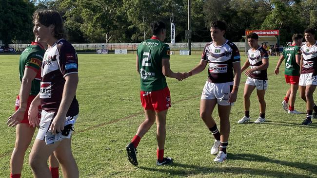 The Burleigh Bears and Wynnum-Manly players exchange handshakes.