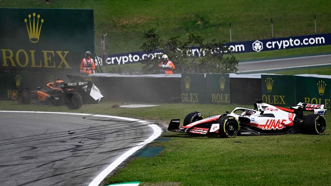 McLaren's Daniel Ricciardo and Kevin Magnussen crashed very early. Picture: MAURO PIMENTEL AFP