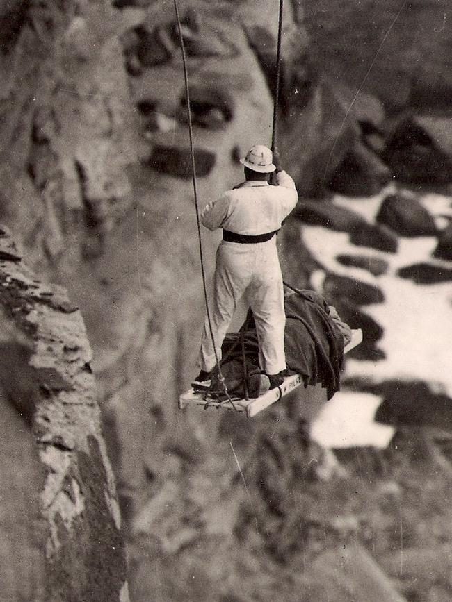 Cliff rescues were very low tech back in the day. Pictured is Ware assisting in removing a body from the bottom of the cliffs. Picture: Supplied