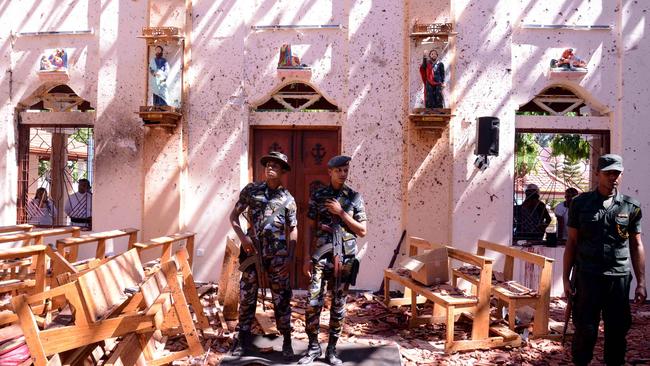 Sri Lankan soldiers look on inside the St Sebastian's Church at Katuwapitiya in Negombo, following a bomb blast. Picture: AFP