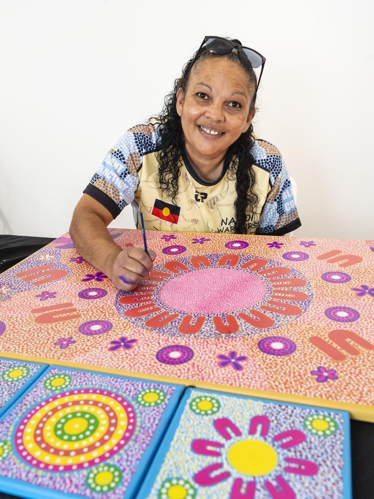 Stacey Trindall of Baru Maranga Art works on a piece of art at her stall at the Indigenous Artisan Markets at The Lighthouse, Saturday, December 17, 2022.