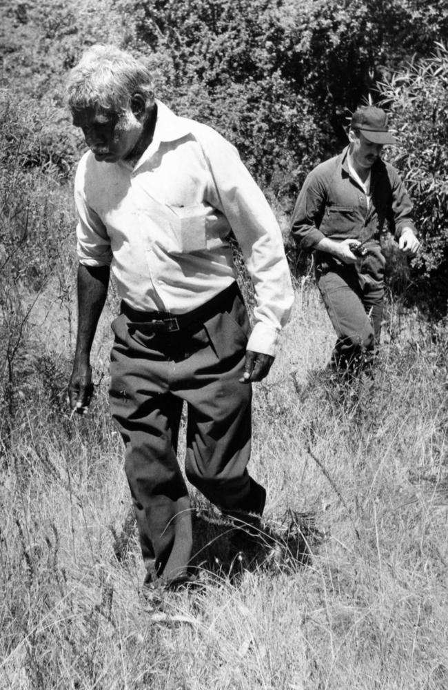 Tracker Jimmy James with police Star Force officer P. Foot searching for a missing man at Coromandel Valley in 1981. 