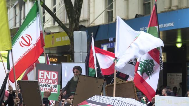 Protesters carry the photo of assassinated Hezbollah leader Hassan Nasrallah at the State Library in Melbourne. Picture: Valeriu Campan