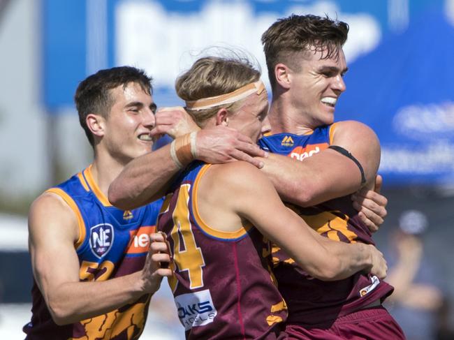 The Brisbane Lions NEAFL side celebrate their Grand Final win over the Southport Sharks.