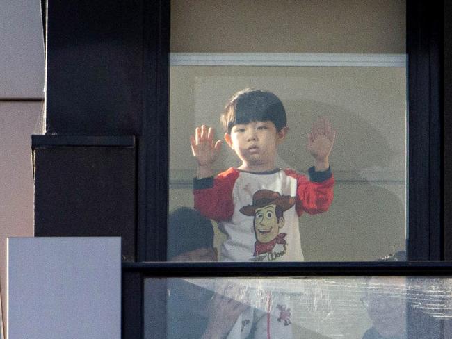 14/07/2021 Residents peer out from the balcony of their Ariele apartment flats in Maribrynong. Aaron Francis/The Australian