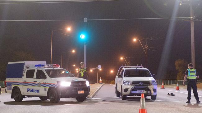 Police cordon off the intersection of Stuart Highway and McMinn Street where the gunman was arrested last night. Picture: AAP