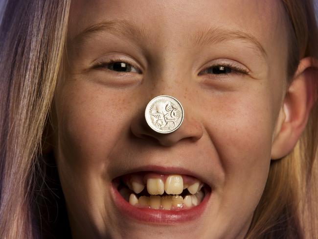 Ava Lacy, 7, with five cent pieces. Picture: Nathan Dyer