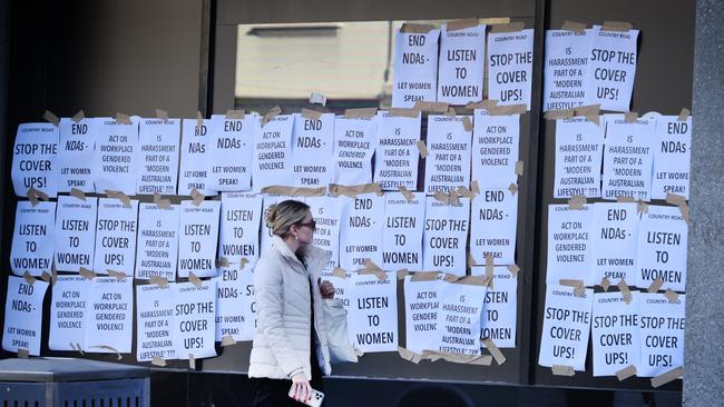 Posters stuck to the outside of Country Road’s Melbourne flagship store. Picture: David Caird