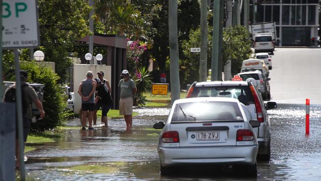 Flooding from the King tide at Budds Beach at Surfers Paradise was made worse by the approaching storm system. Locals watch the water rise. Picture Glenn Hampson