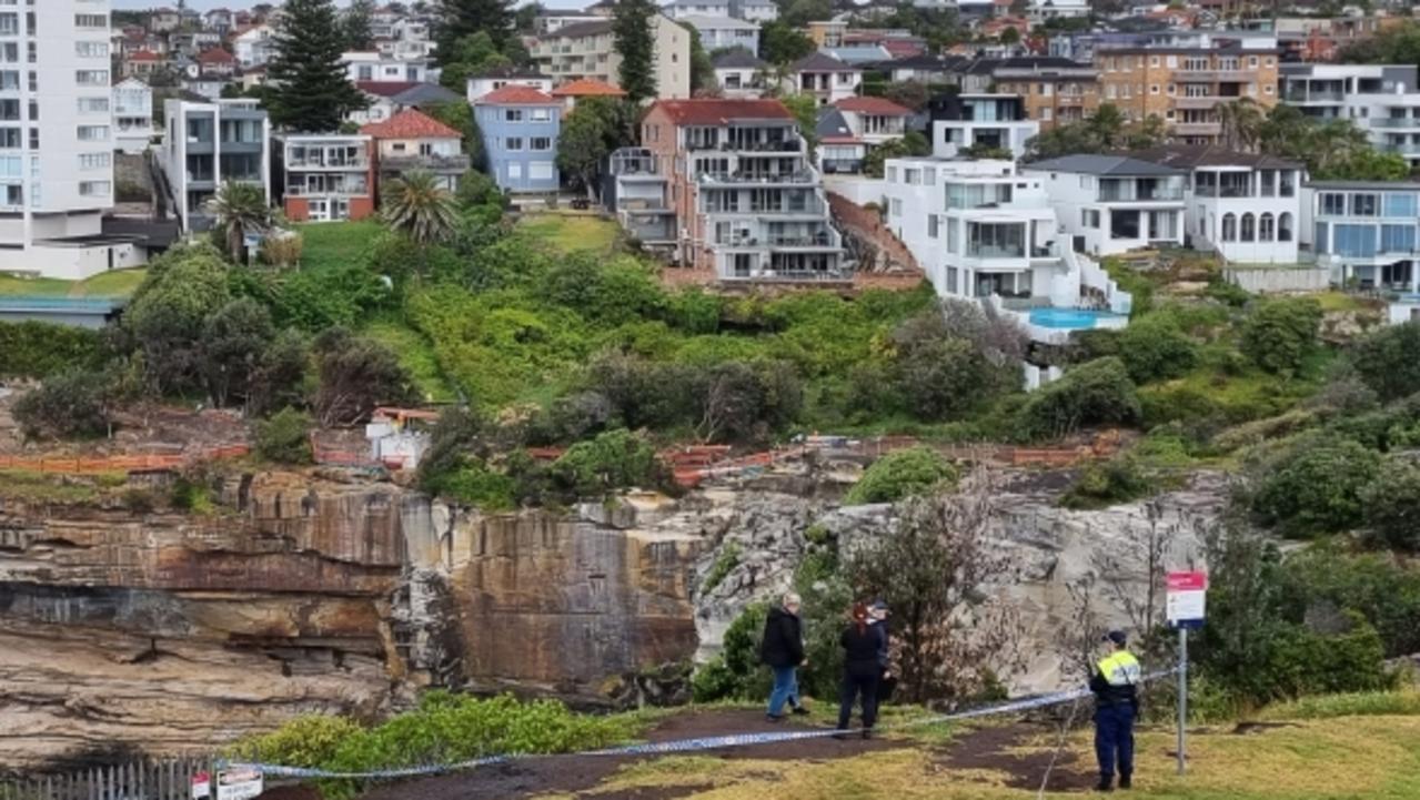 A crime scene has been established at The Gap in Vaucluse where police are also searching for a male in relation to a woman’s body found at St Andrew's Cathedral School in Sydney CBD.