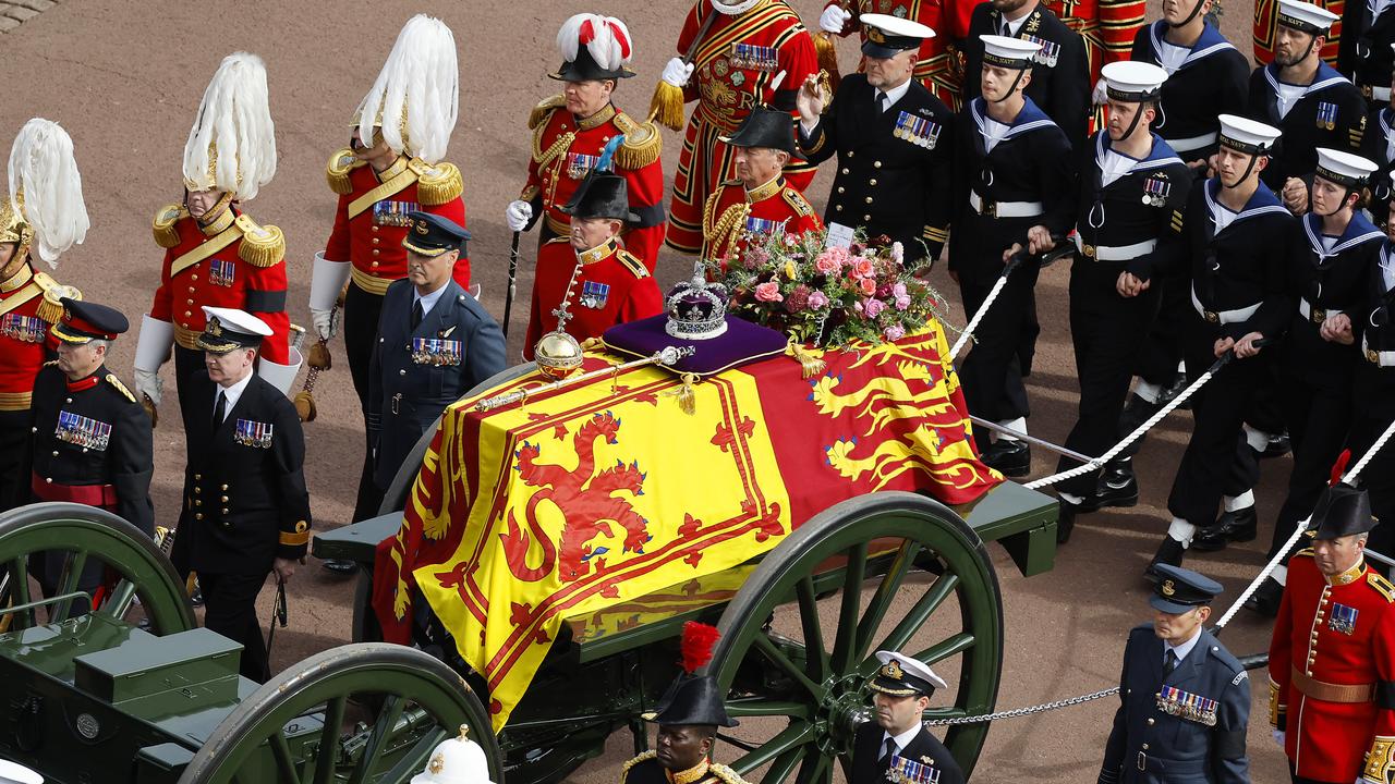 The Queen's funeral cortege borne on the State Gun Carriage of the Royal Navy travels along The Mall.