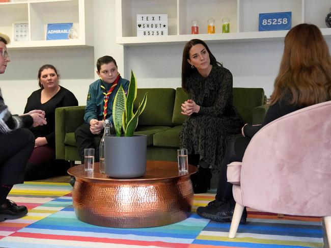 Kate Middleton talks to staff members during her visit to the charity Shout. Picture: AFP