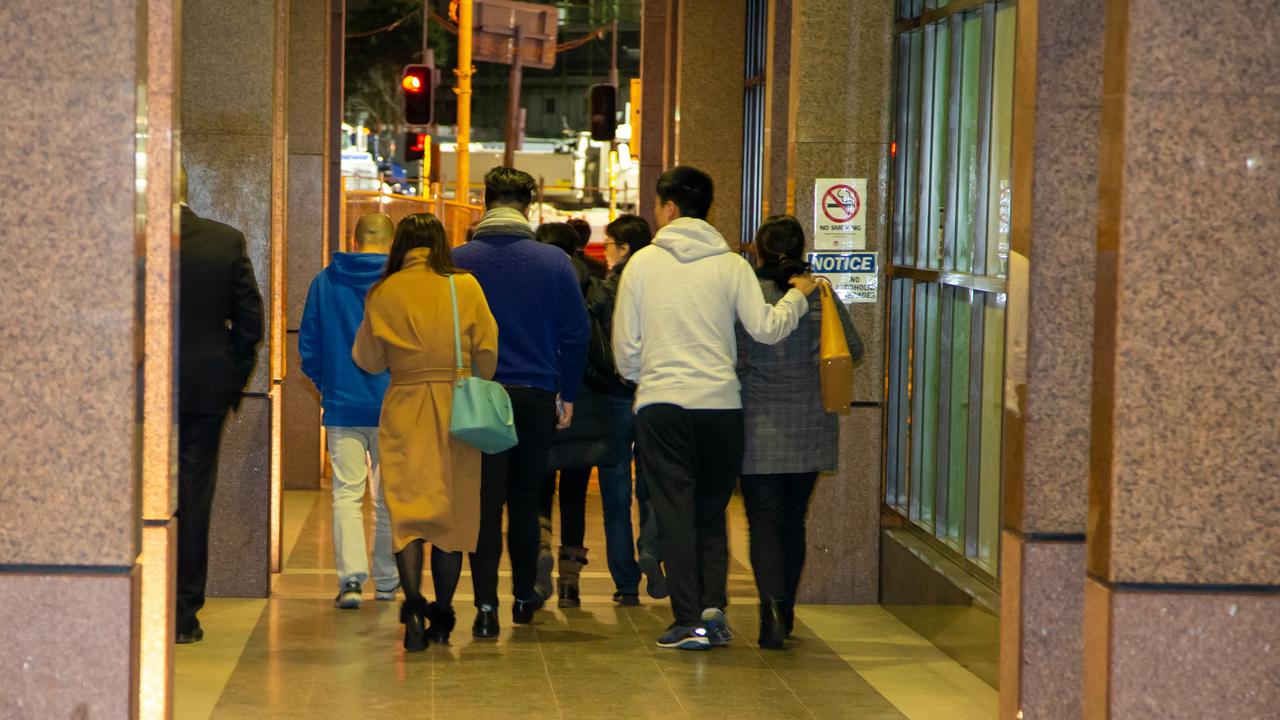 Unit owners from Mascot Towers leaving the third extraordinary general meeting.