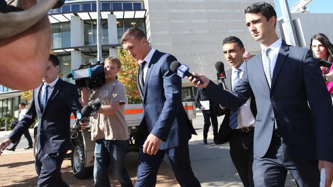 Wighton walks through the media pack after leaving court. (Kym Smith)