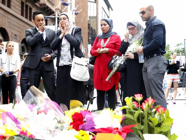 Zaahir Edries, Silma Ihram, Mariam Veiszadeh, Lydia Shelly and Ahmed Aboushabn visit the flower memorial in Martin Place. Picture: Bradley Hunter